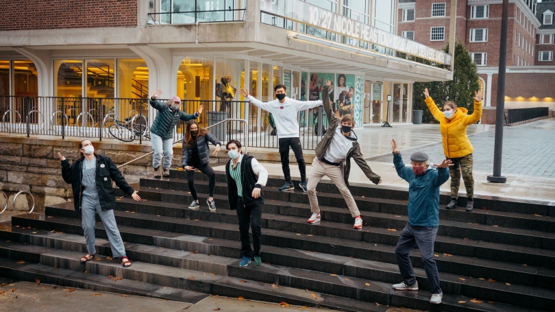 Hanover-based cast and crew of Faith, Hope, and Charity posing dramatically on Hopkins Center steps, masks on.